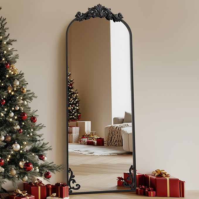Arched freestanding full-length mirror with elegant frame, placed in a modern room setting.