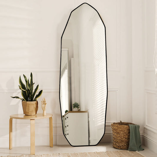 Irregular full-length mirror with sculptural frame, styled in a modern living space
